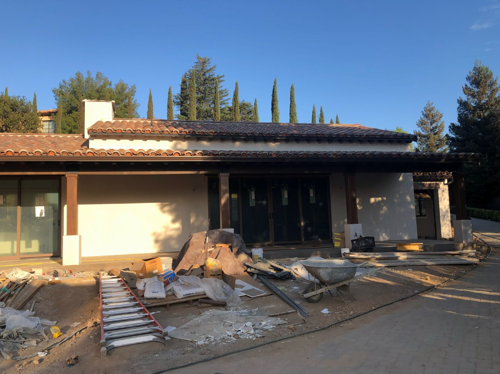 ADU exterior construction progress with clay barrel tile roof and covered terrace