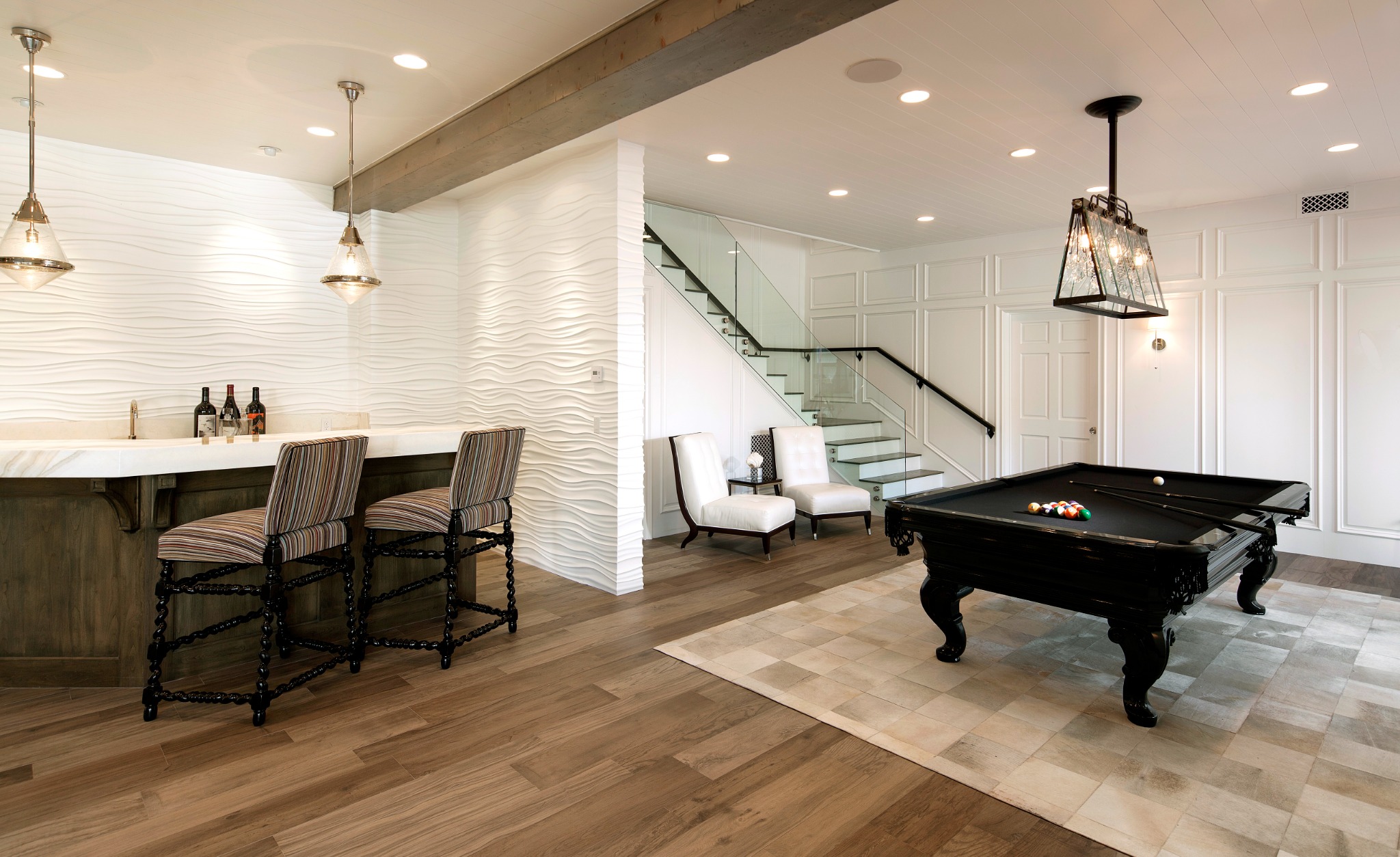 Garden Estate game room with billiards table, bar, sculpted wall finish, and glass stair guard