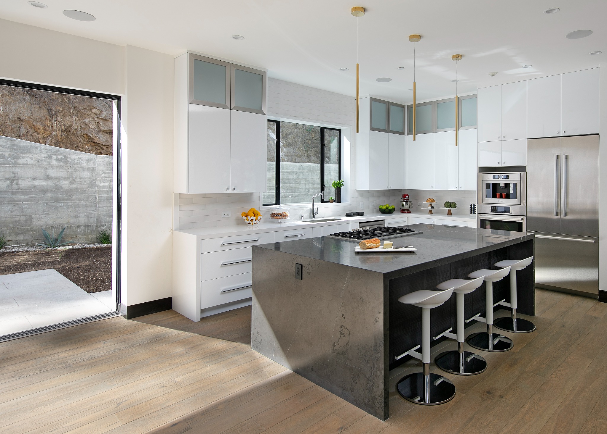Sunset Plaza kitchen with stone island and brass pendants