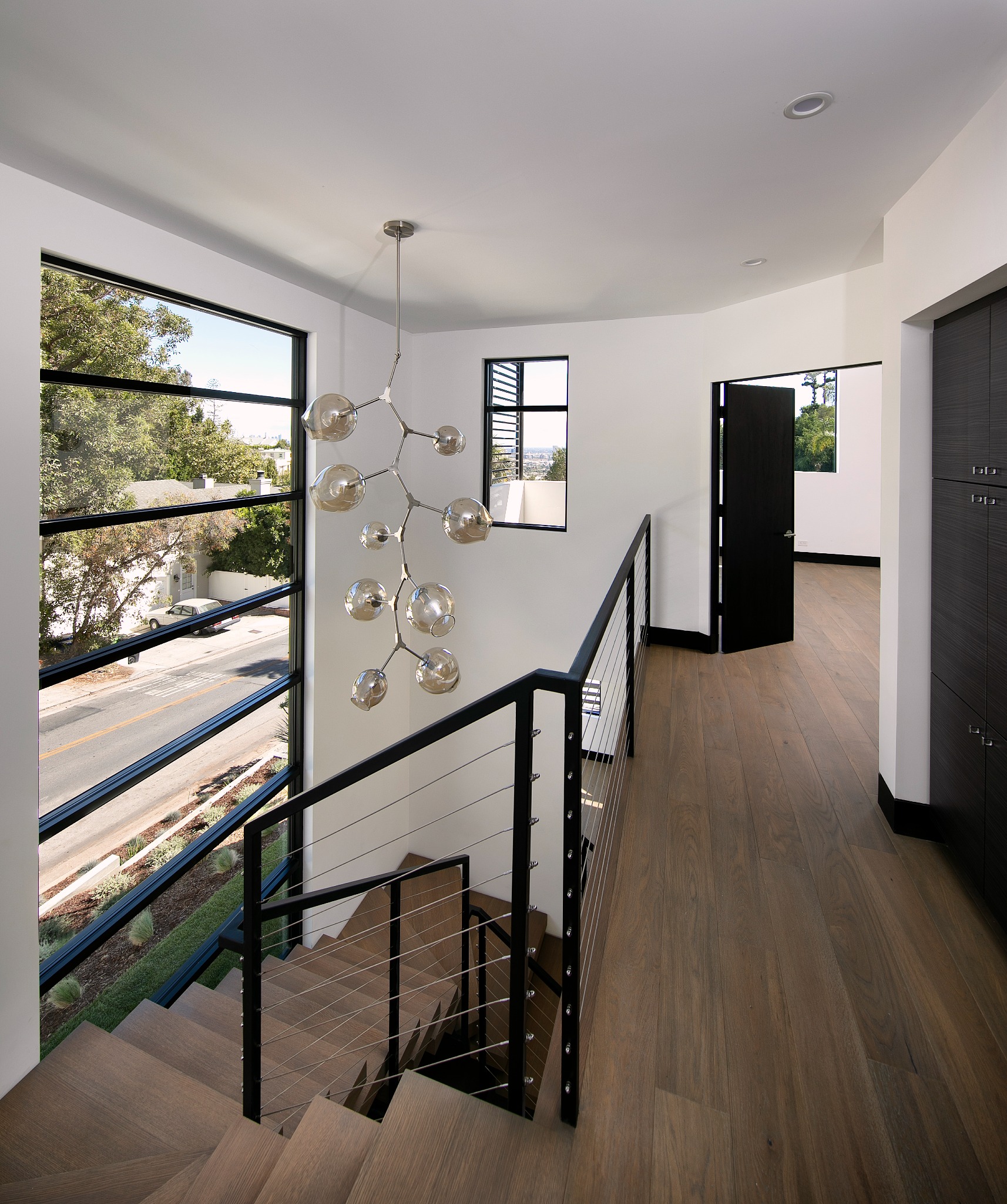 Sunset Plaza upper stair landing with sculptural pendant